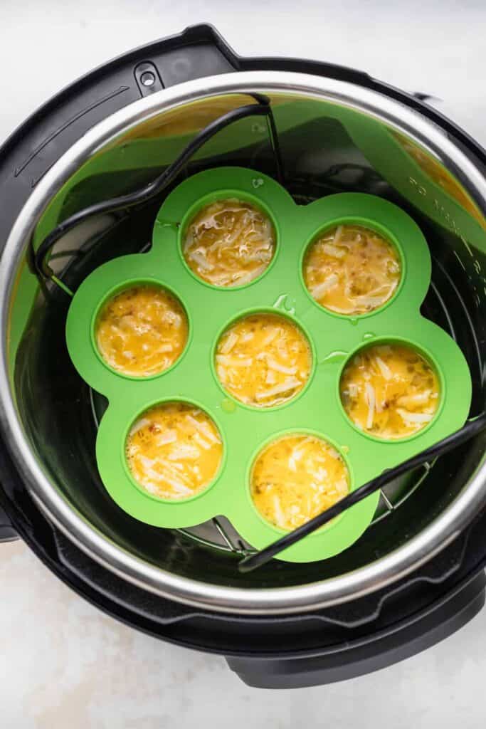 Instant pot cheesy egg bites inside the instant pot ready to be pressure cooked.