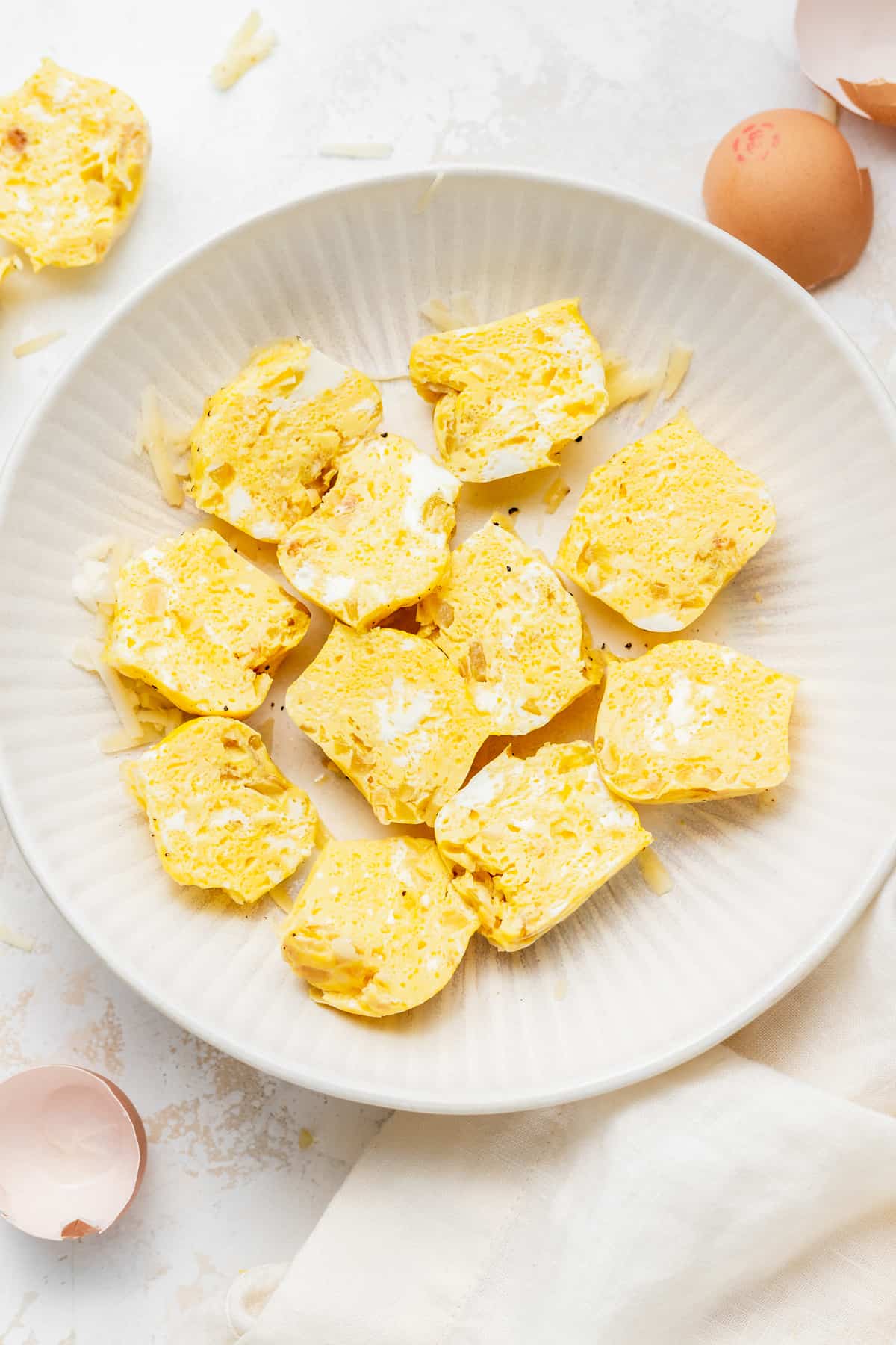 Instant pot cheesy egg bites on a plate cut in half.