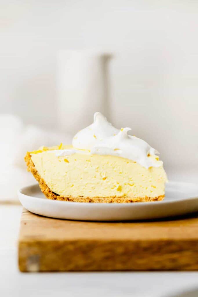 A slice of cream cheese lemonade pie on a plate. 