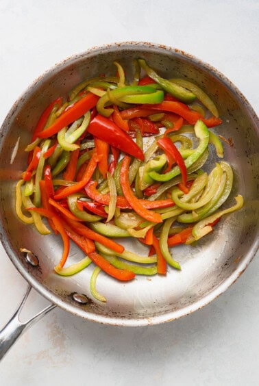 stir fried peppers in a frying pan.