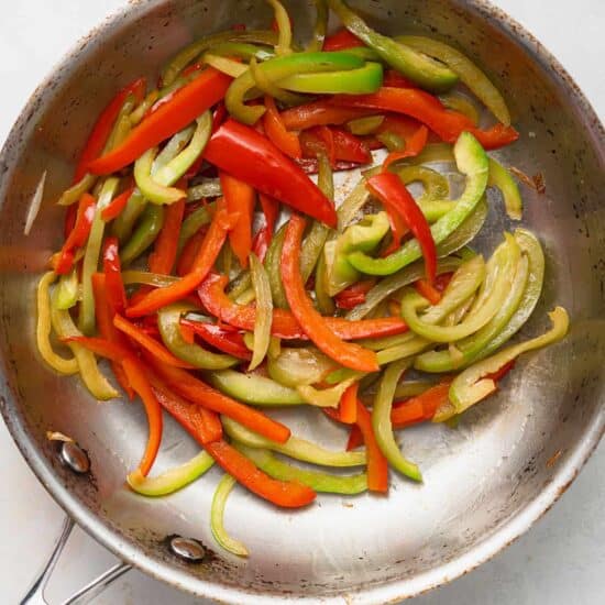stir fried peppers in a frying pan.