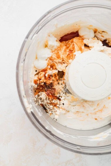 a food processor with ingredients in it.