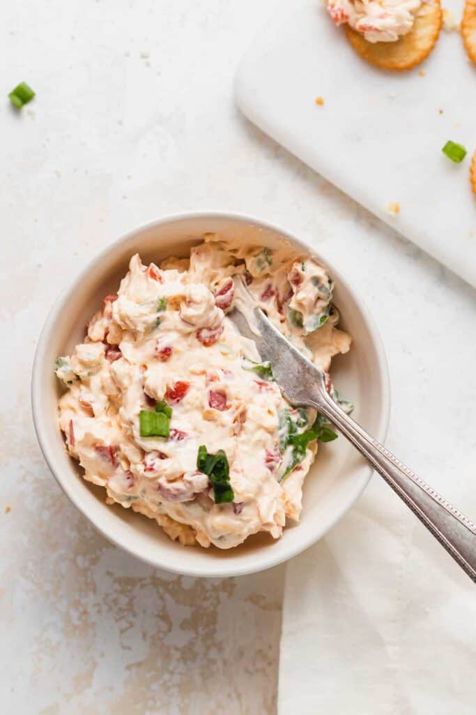 pimento cheese with knife in bowl