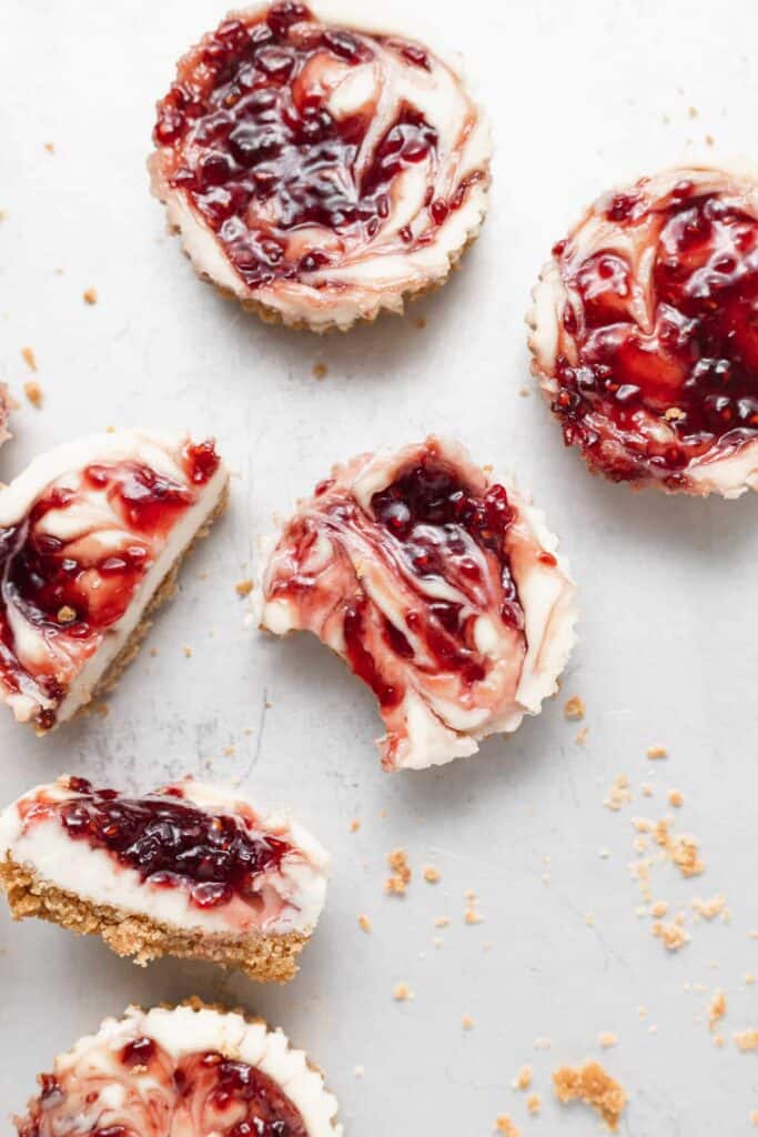 Raspberry cheesecake bites with bites taken out of them.