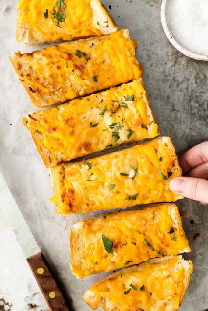 Garlic bread with chopped parsley on top. 