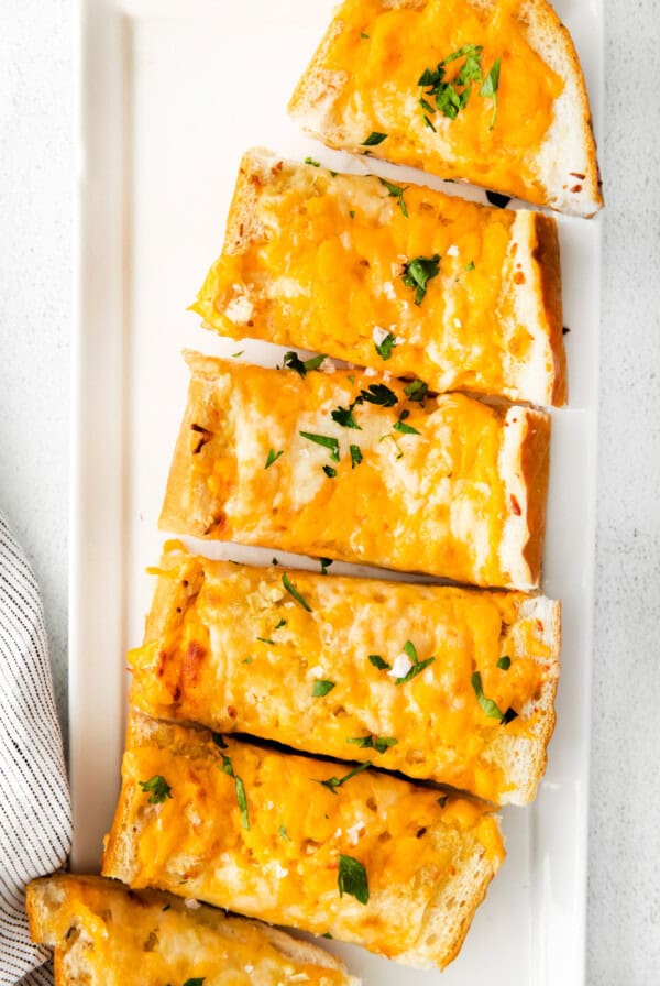 Cheesy garlic bread on plate.