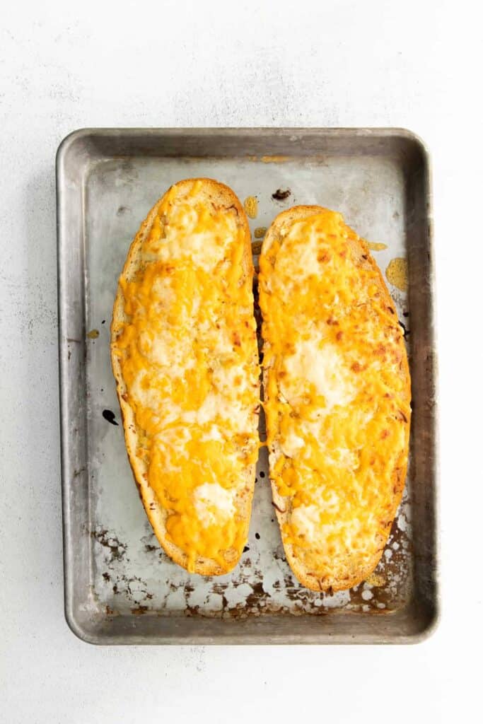 Baked garlic bread on a baking sheet. 