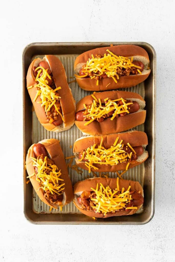 Pan of chili cheese dogs.