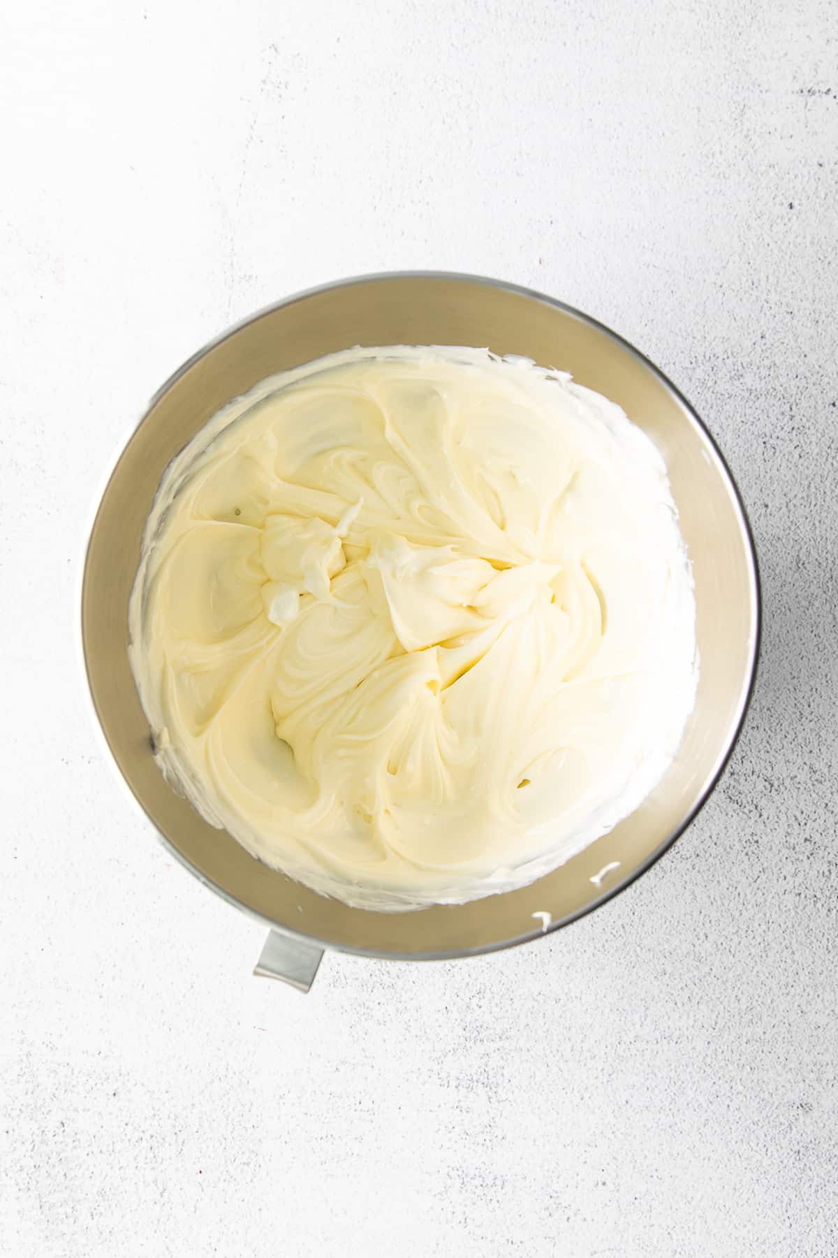 cream cheese and sugar whipped in a bowl