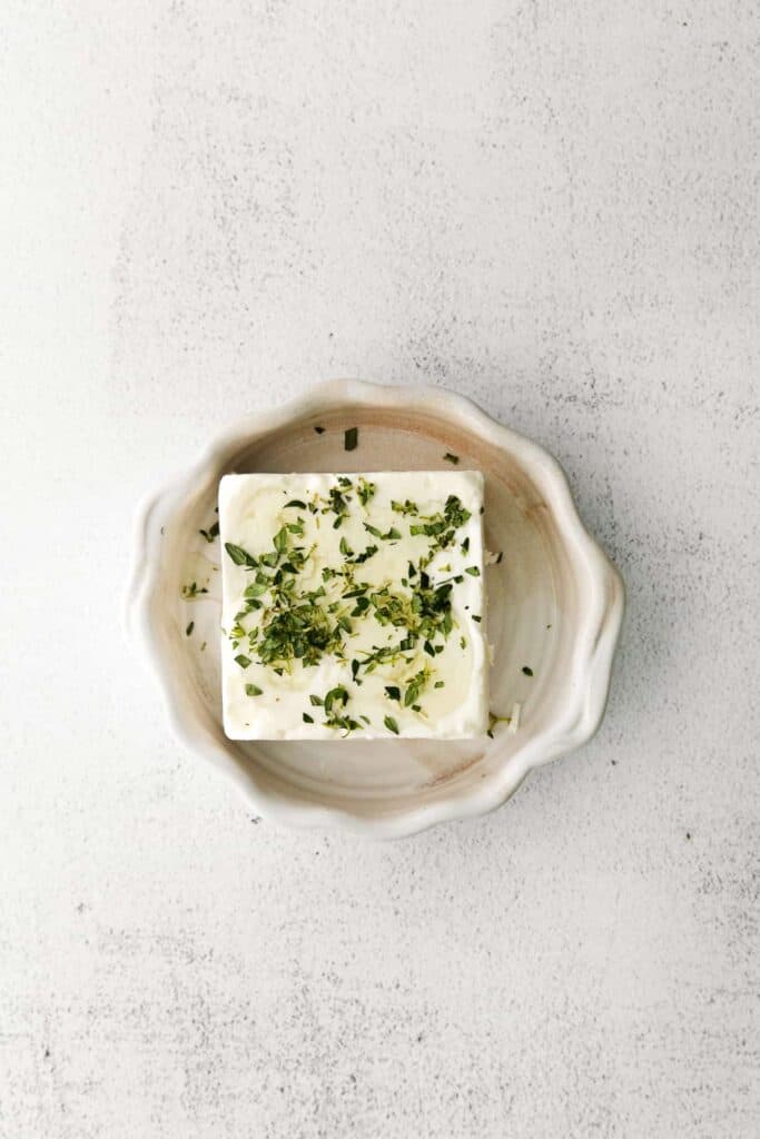 A block feta with fresh thyme, olive oil, salt, and honey. 