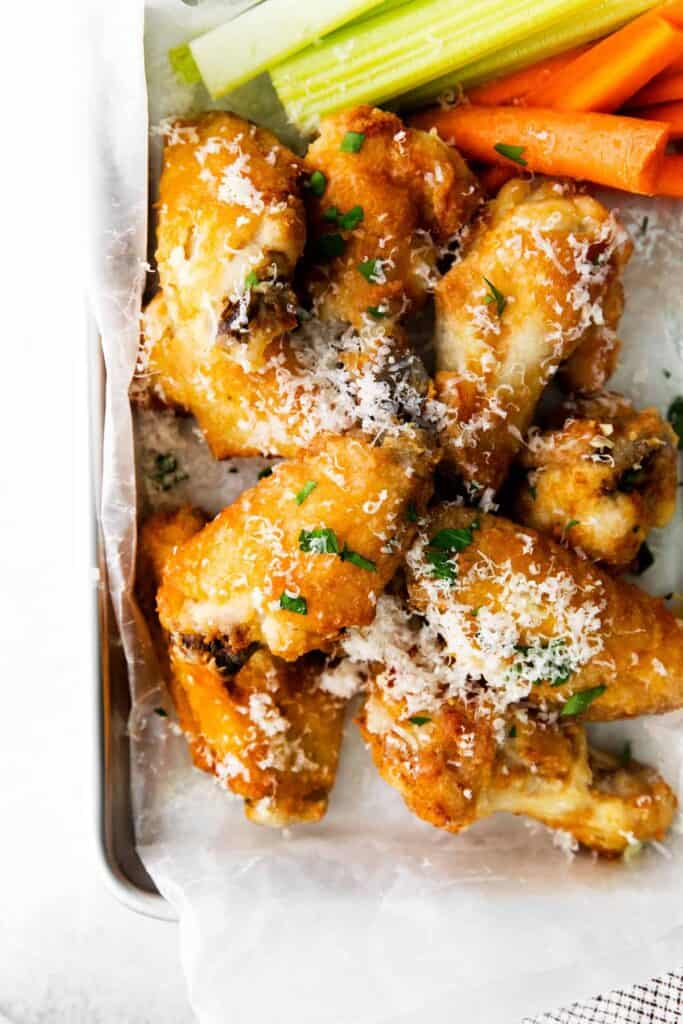 air fryer garlic parmesan wings topped with grated parmesan cheese