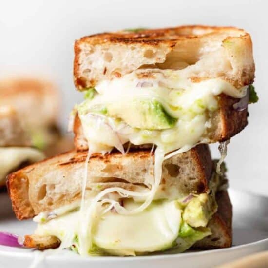 a stack of avocado grilled cheese sandwiches