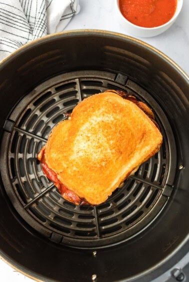 a grilled sandwich in an air fryer.
