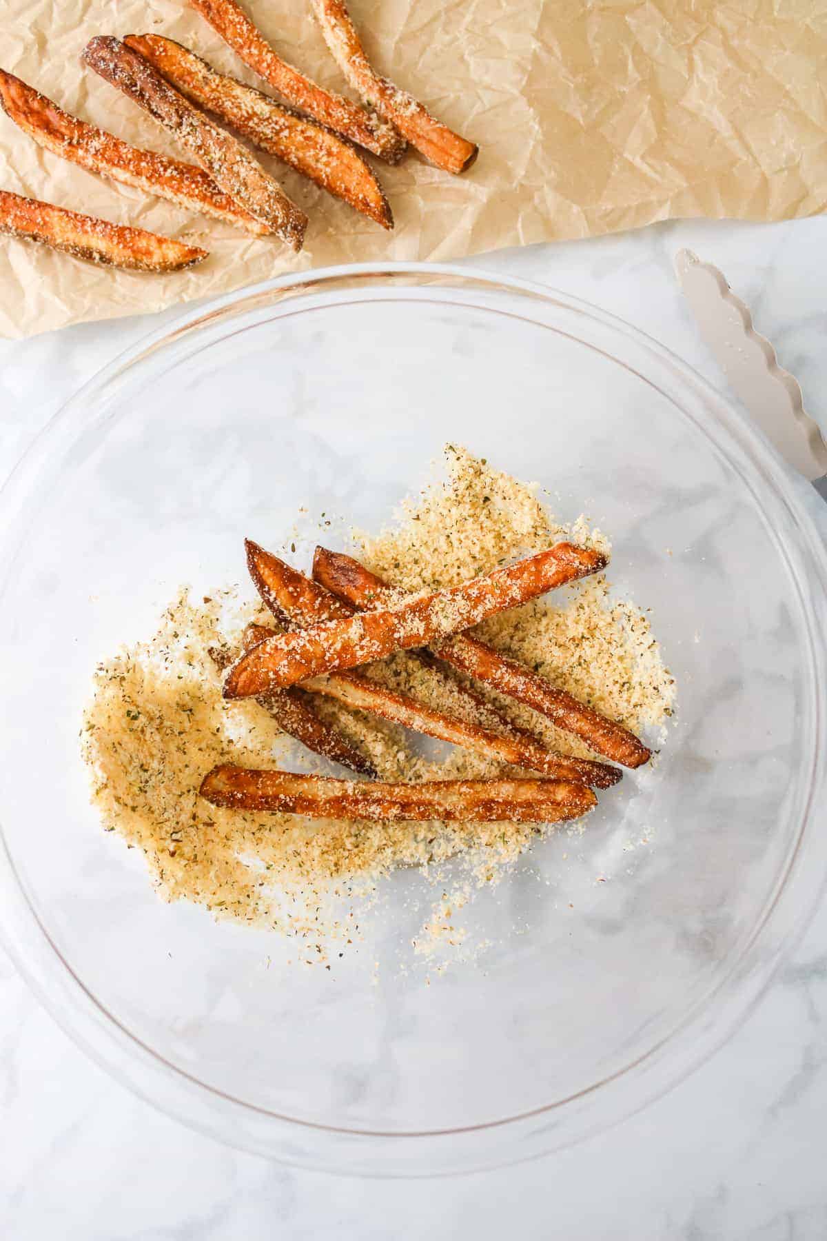 tossing fries in spices and cheese