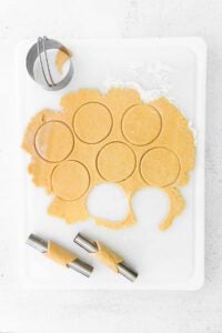 Cutting circles out of cannoli dough.