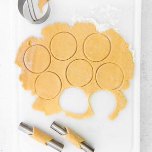 Cutting circles out of cannoli dough.