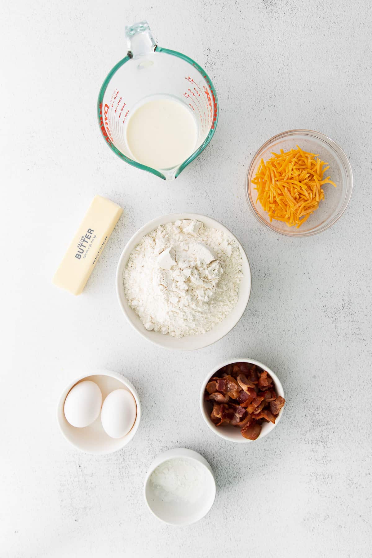 All the ingredients for bacon and cheddar scones on the counter top. 