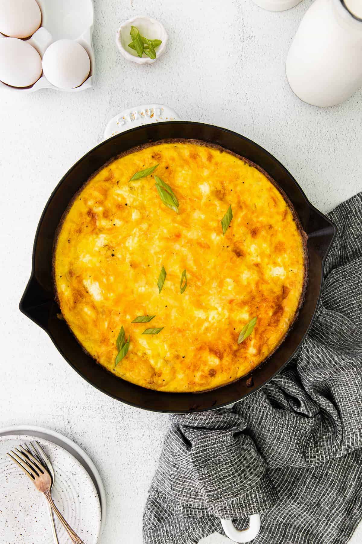 four cheese frittata in a baking dish ready to be sliced and served