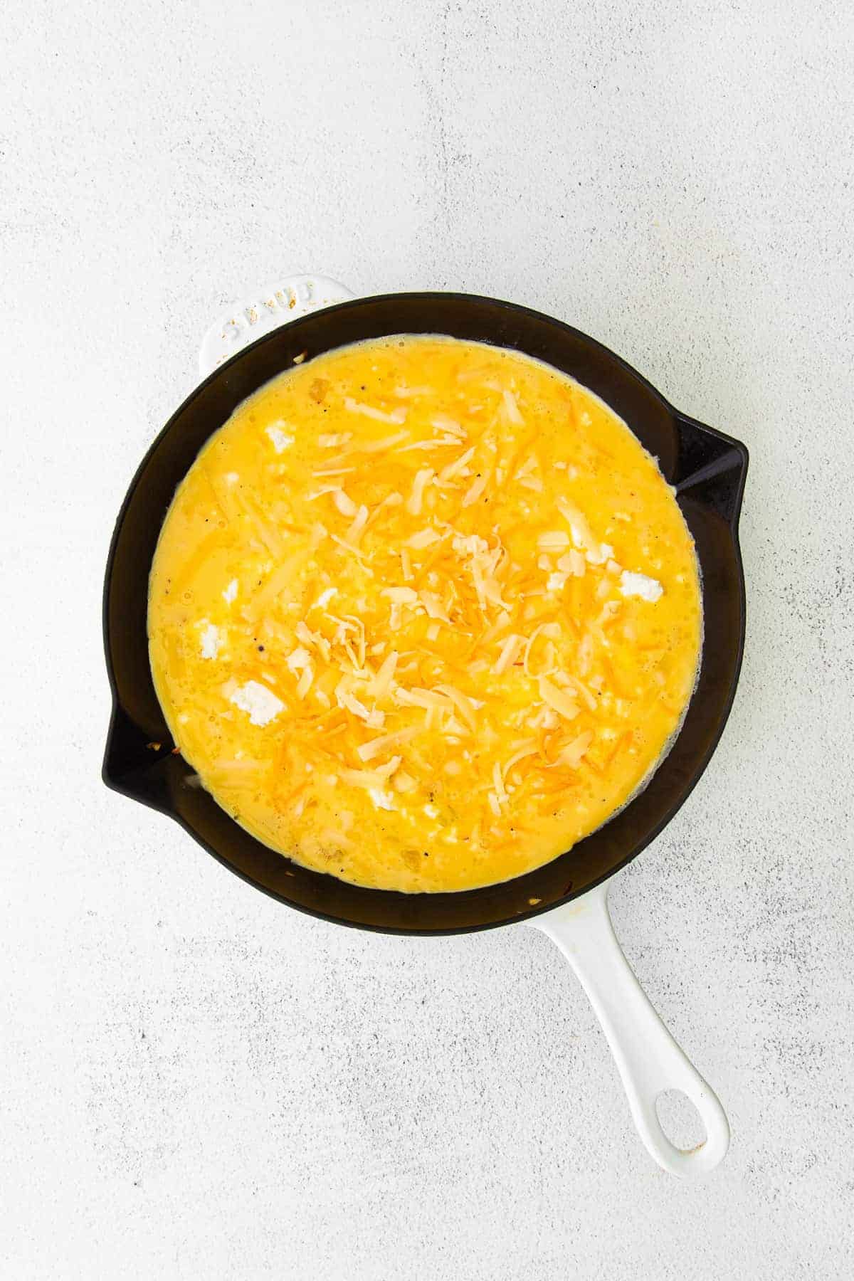 four cheese frittata ready to be placed in the oven to be baked