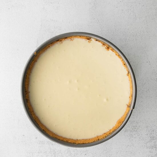A classic cheesecake displayed on a white background.