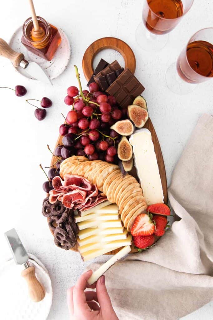 chocolate and cheese board with crackers, grapes, cheese and chocolate bars