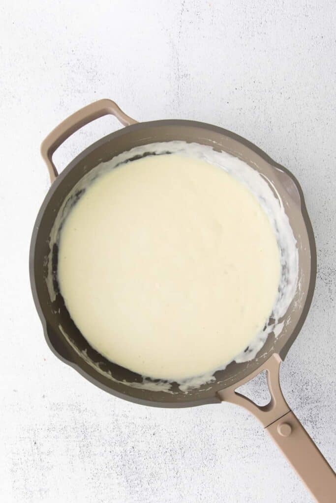 creamy alfredo sauce in a skillet.