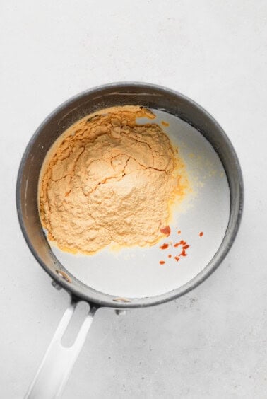 a frying pan with a mixture of flour and spices.