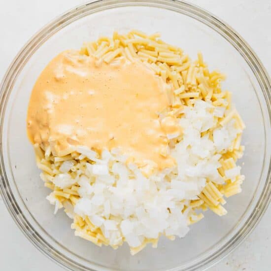 a bowl of rice and sauce in a glass bowl.
