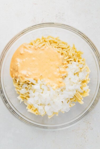 a bowl of rice and sauce in a glass bowl.