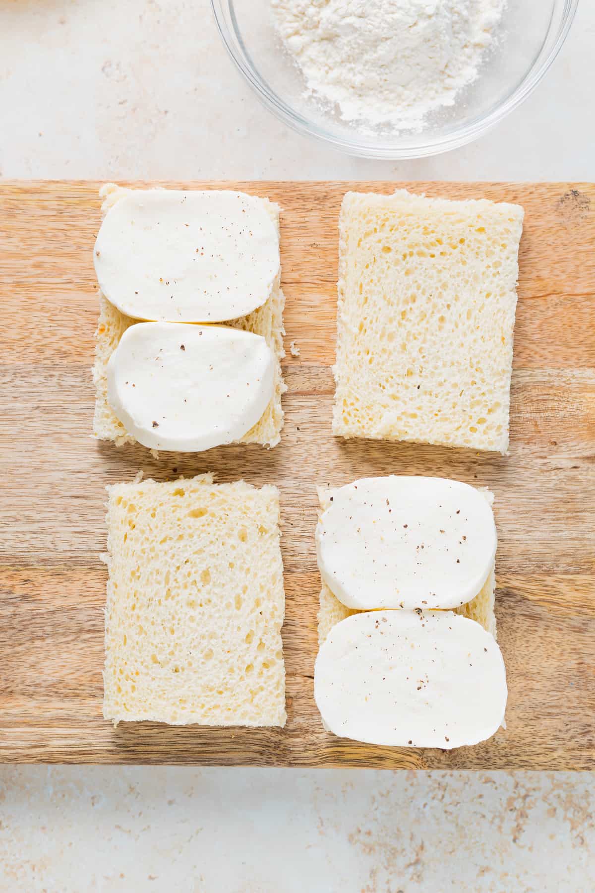 sliced fresh mozzarella on white bread, ready to be made into mozzarella in carrozza