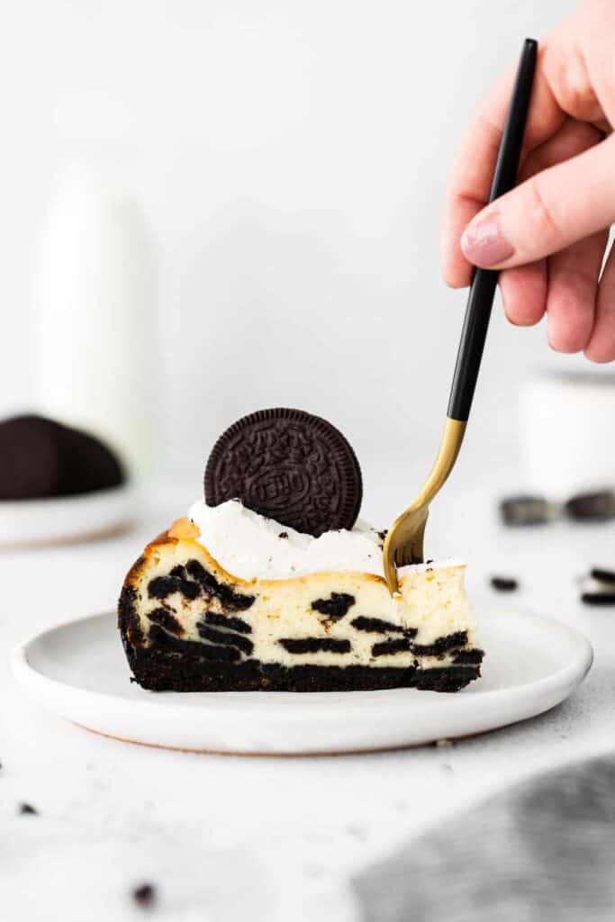 slice of oreo cheesecake with a bite on a fork