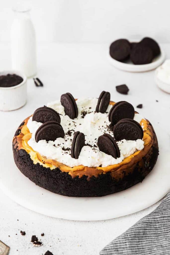 oreo cheesecake topped with whipped cream and oreos, ready to be served