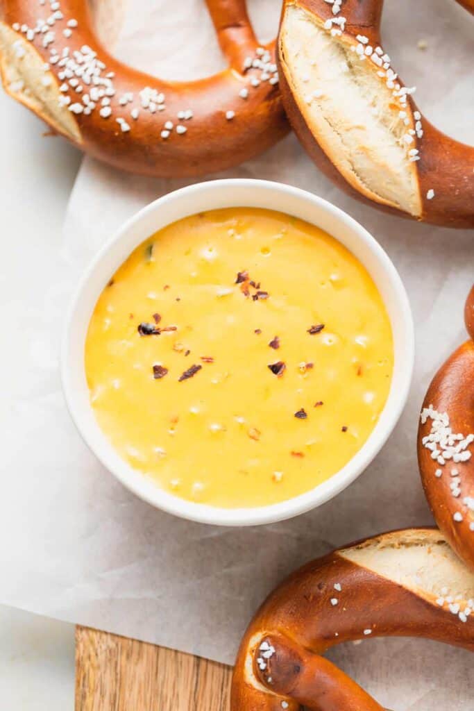 pretzel cheese dip in a bowl served next to soft pretzels