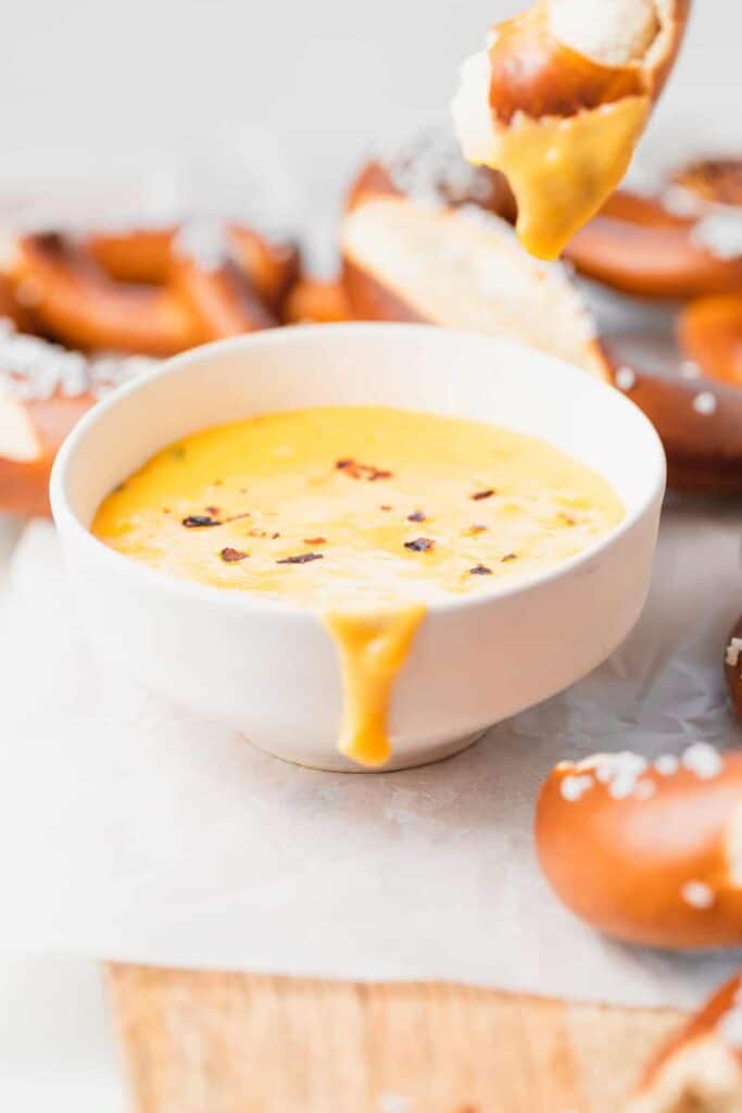 pretzel cheese dip looking melty and delicious in a bowl