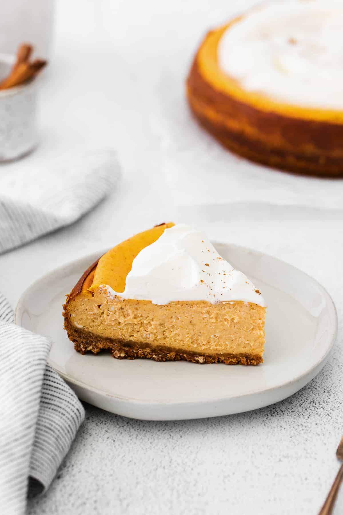 slice of pumpkin chai cheesecake on a plate