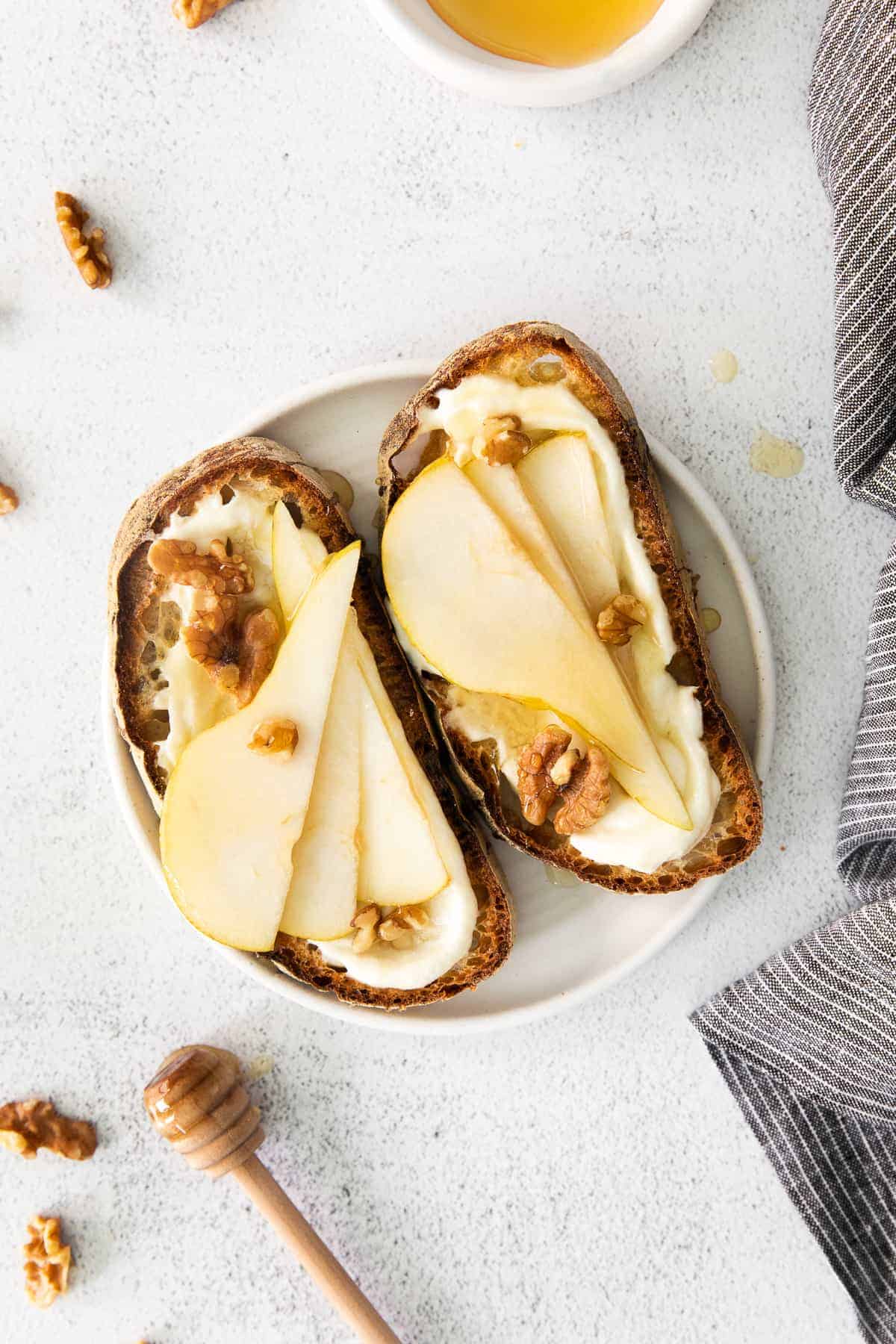 Ricotta toast with pears and walnuts on top. 