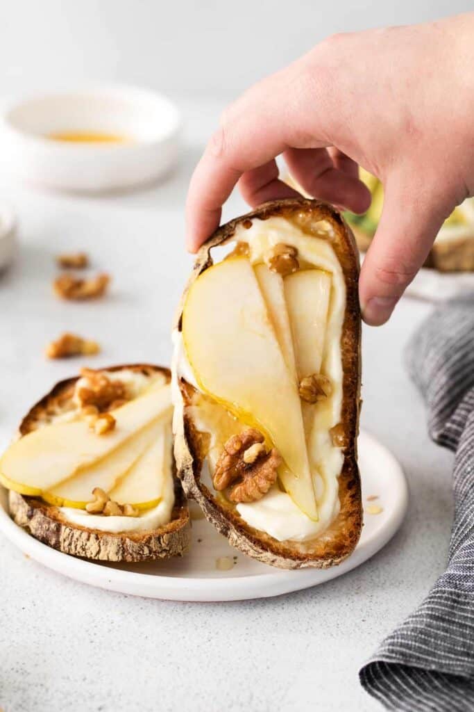 Ricotta toast topped with honey, pears, and walnuts. 