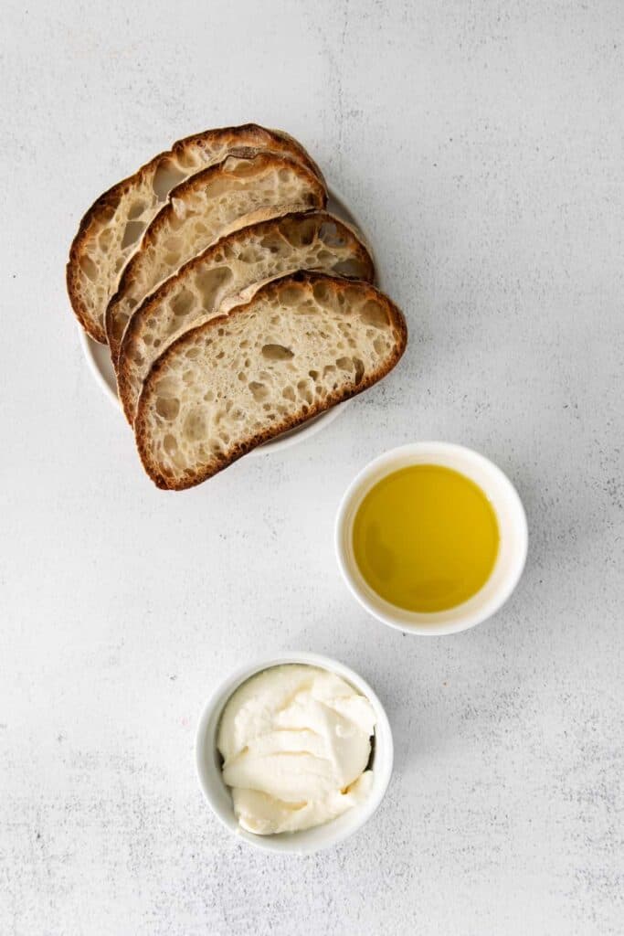 Bread, olive oil, and ricotta cheese. 