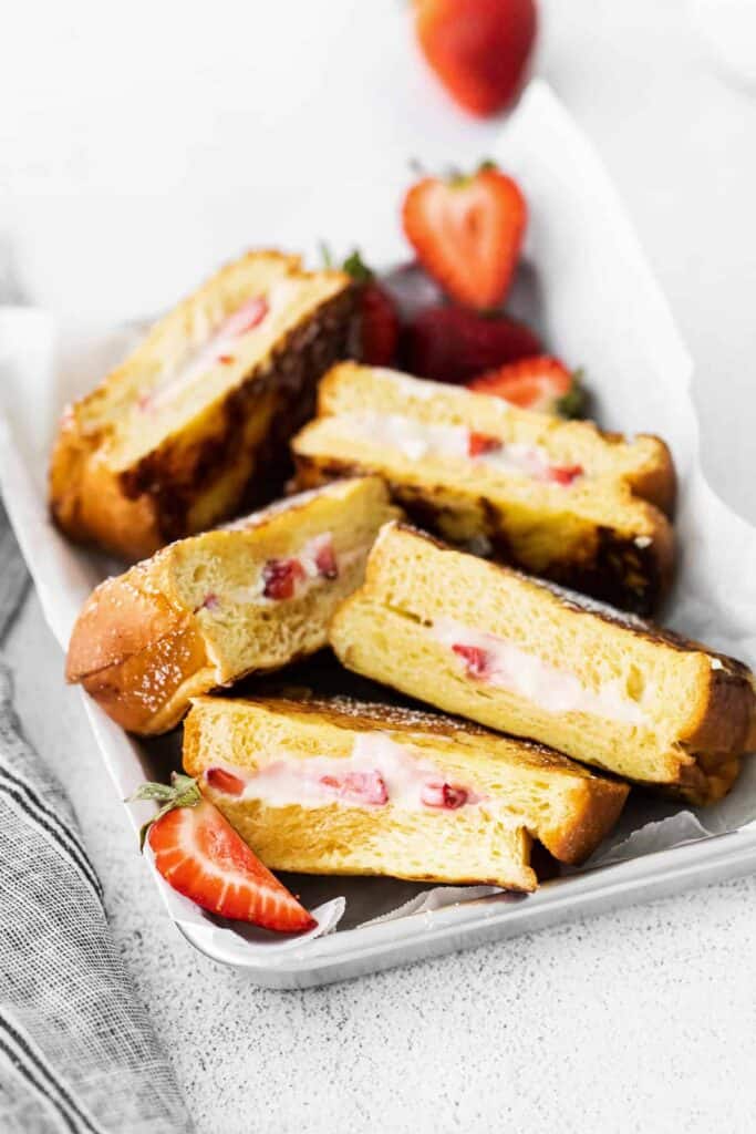 Strawberries and cream french toast in a serving tray.