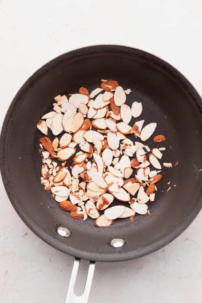 slivered almonds in a skillet ready to be toasted