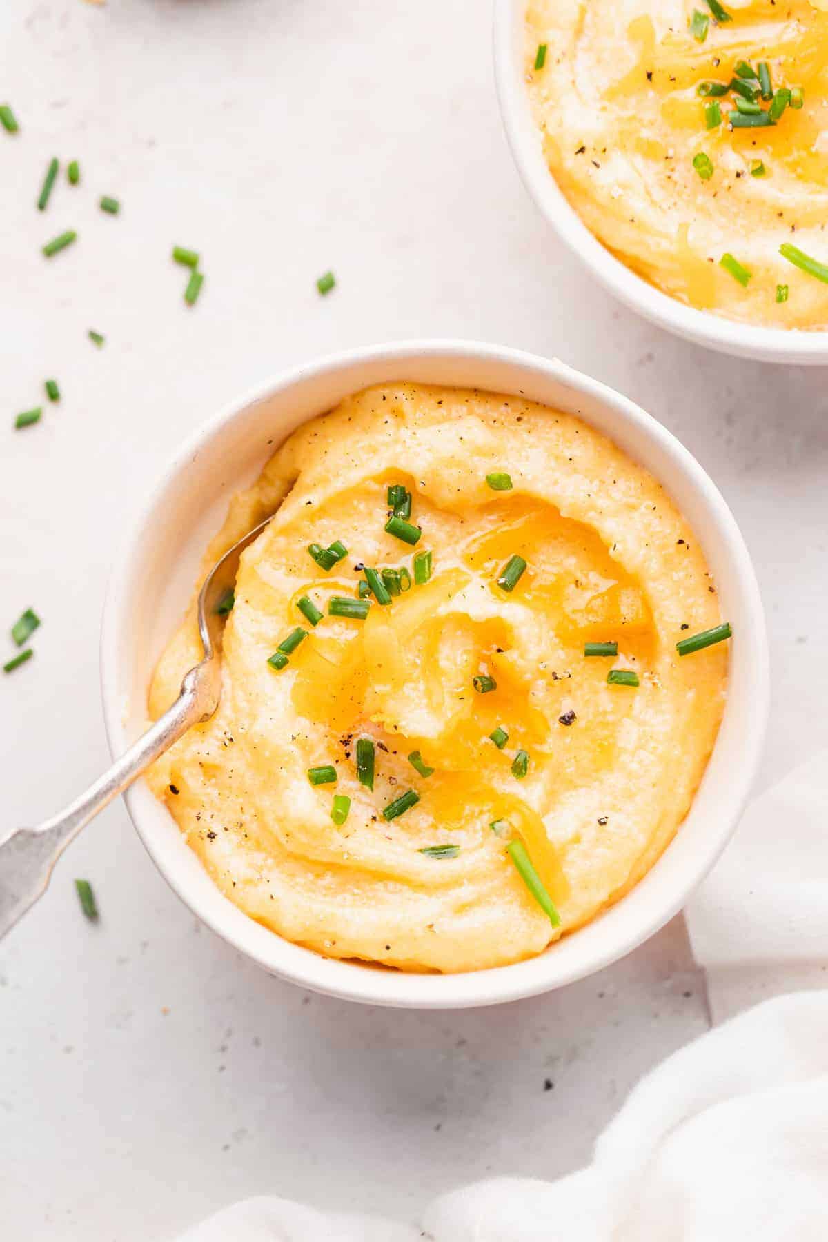 cheese grits in a bowl topped with chives