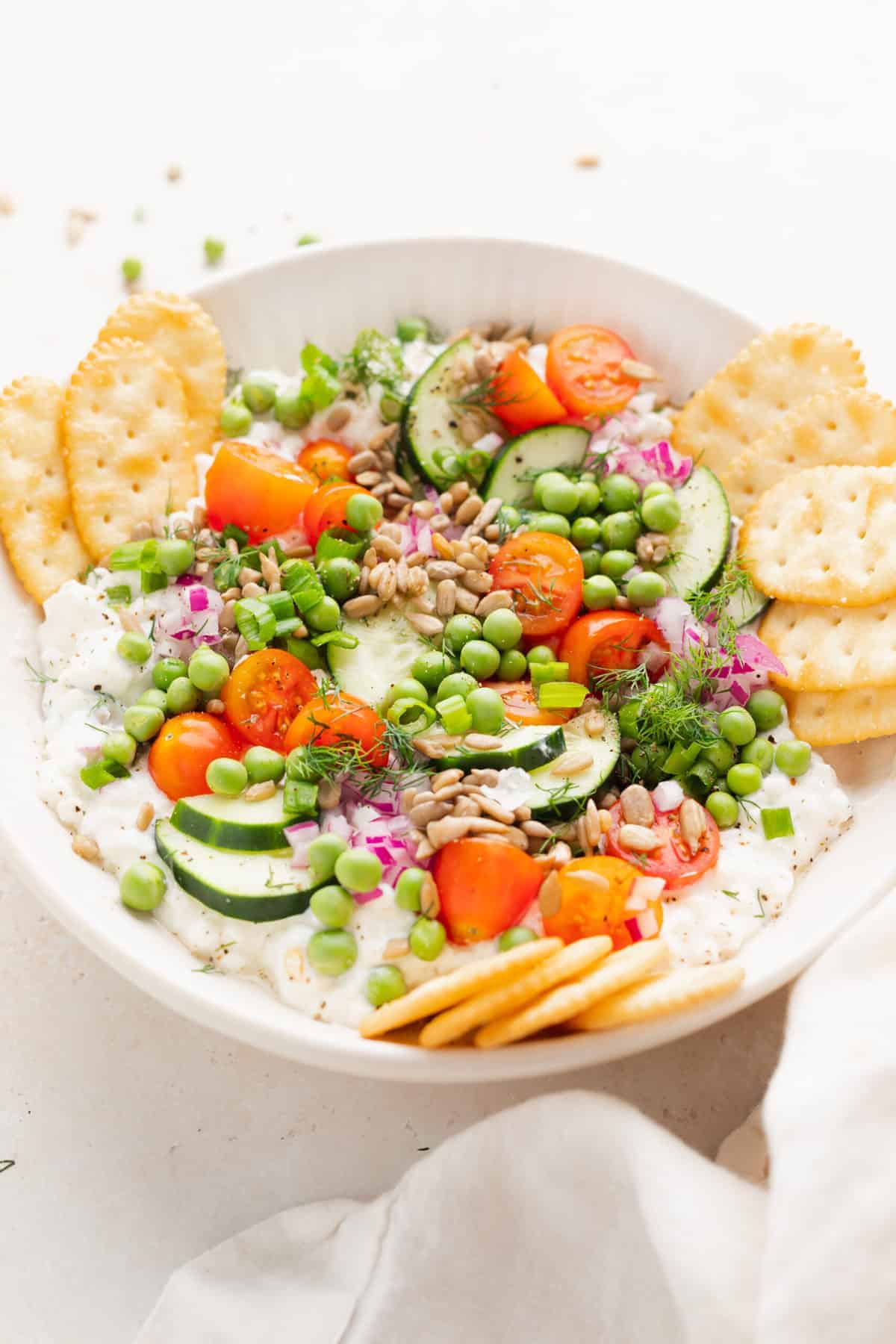 Cottage cheese salad in a bowl with crackers.