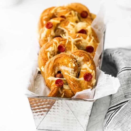 cheesy pretzels in a silver tray with a napkin.