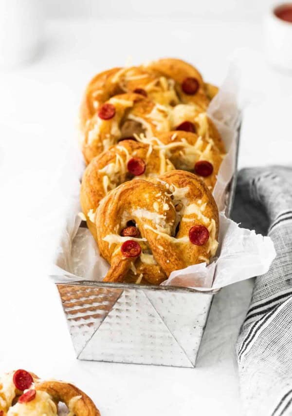 cheesy pretzels in a silver tray with a napkin.