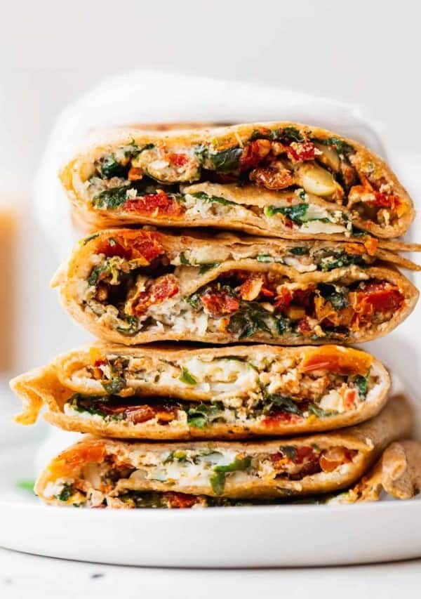a stack of spinach and artichoke quesadillas on a white plate.