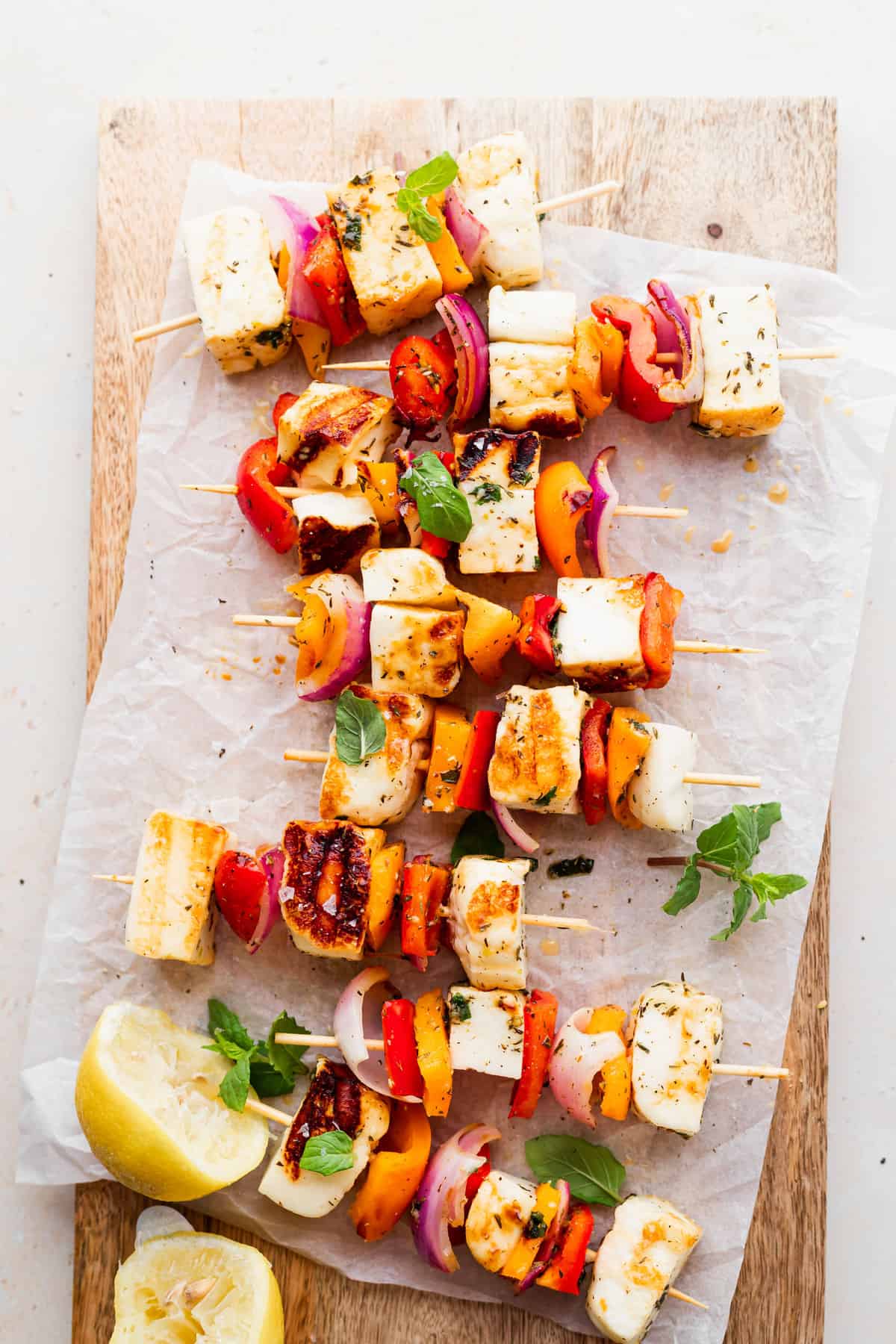 grilled halloumi skewers on a cutting board, ready to be served