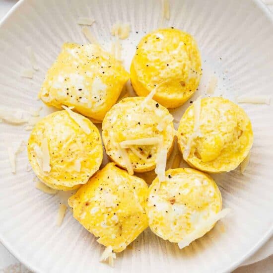 An instant pot with cheesy egg bites, including parmesan, served on a white plate.