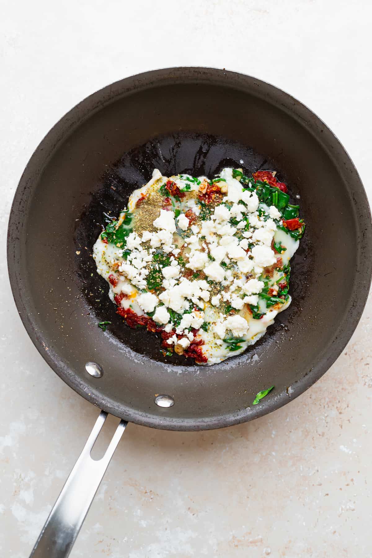 Eggs and other ingredients in a skillet pan. 