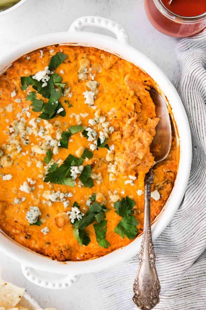 Buffalo Chicken Dip in a white casserole dish. 