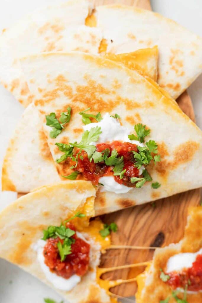 sliced cheese quesadilla with toppings